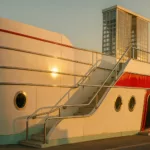 Streamline Moderne seafront pavilion with curved white facade at golden hour