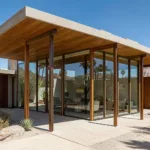 Mid-century modern desert house with flat roof and glass walls at midday